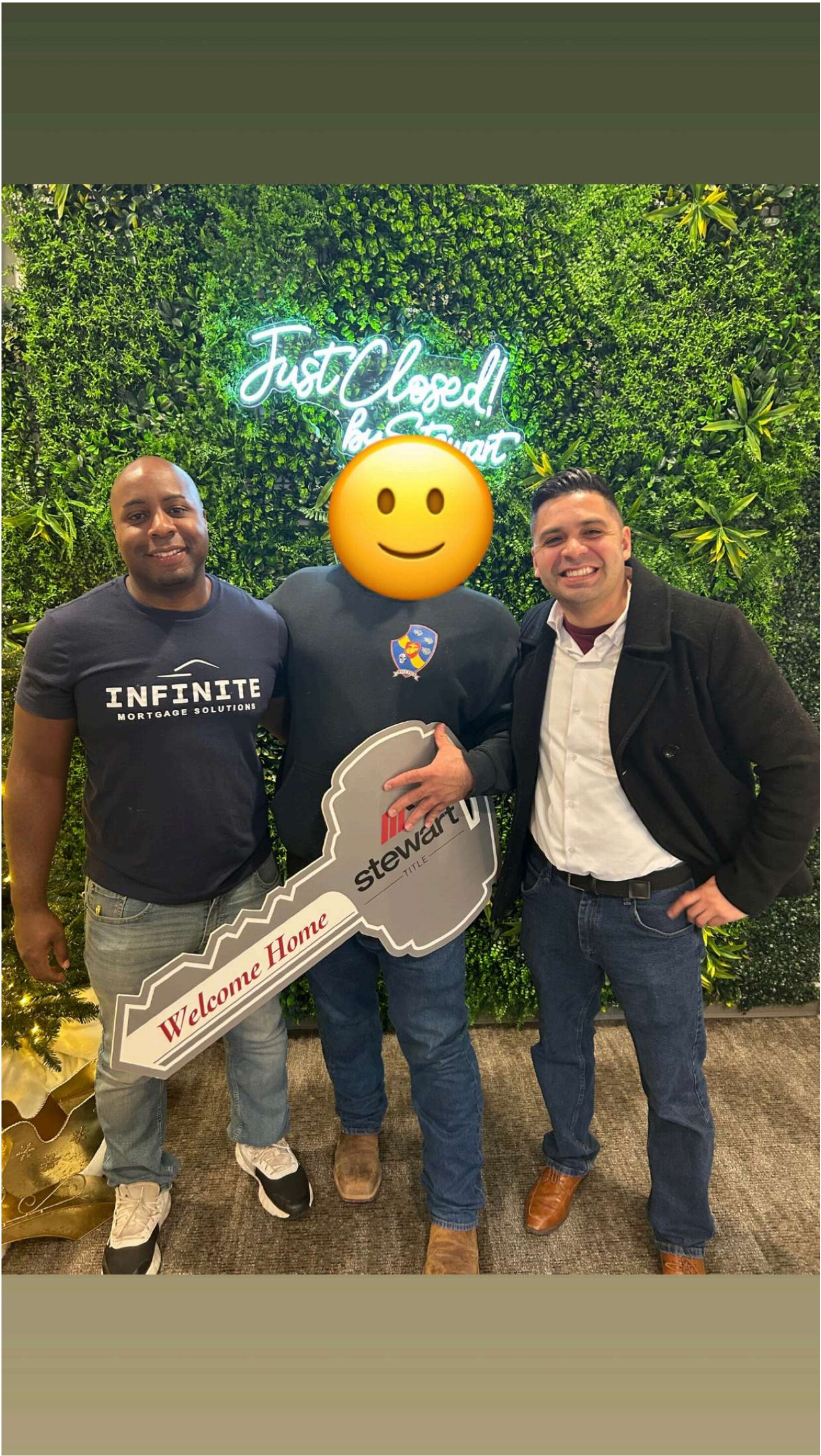 Happy buyers holding a giant key on closing day